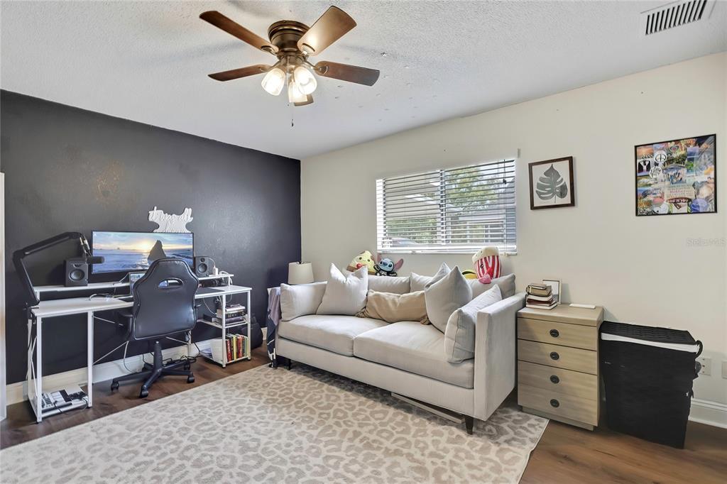14154 Trollman Street Spring Hill, FL 34609 - Photo 16 of 25 a living room with furniture and a window