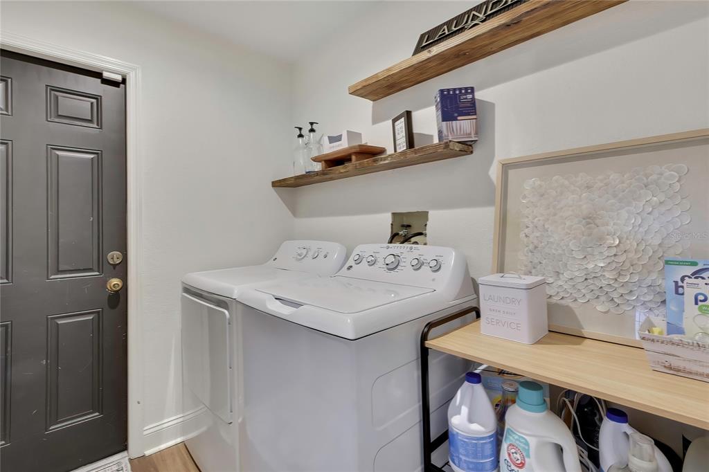 14154 Trollman Street Spring Hill, FL 34609 - Photo 20 of 25 a room with a sink a stove and wooden floor