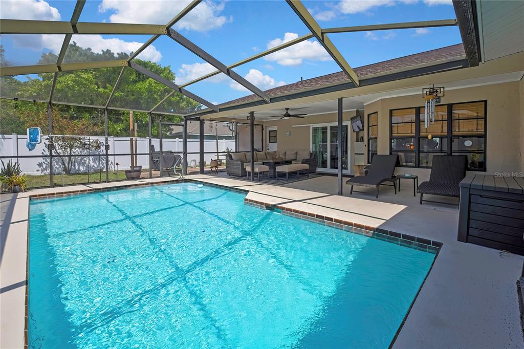 14154 Trollman Street Spring Hill, FL 34609 - Photo 2 of 25 a view of a backyard with sitting area