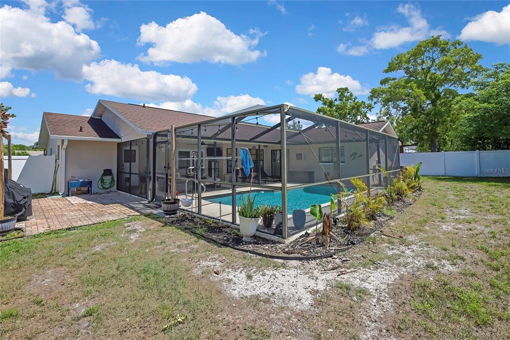 14154 Trollman Street Spring Hill, FL 34609 - Photo 21 of 25 a view of a backyard with a trampoline
