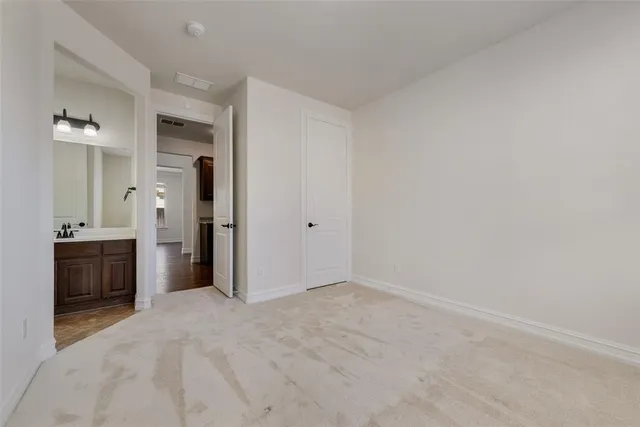 a view of a kitchen with refrigerator and a sink
