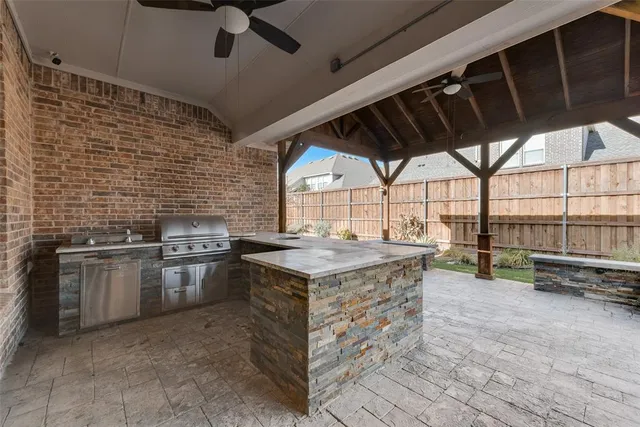 a open kitchen with stainless steel appliances granite countertop a stove and a kitchen island