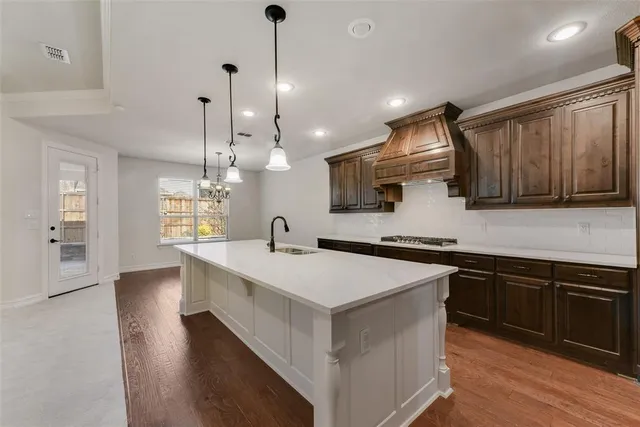 a kitchen with a sink stove and wooden cabinets