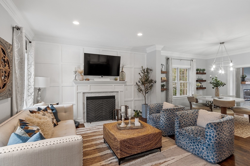 75 Chestnut Street Foxboro, MA 02035 - Photo 2 of 30 a living room with furniture a fireplace and a flat screen tv