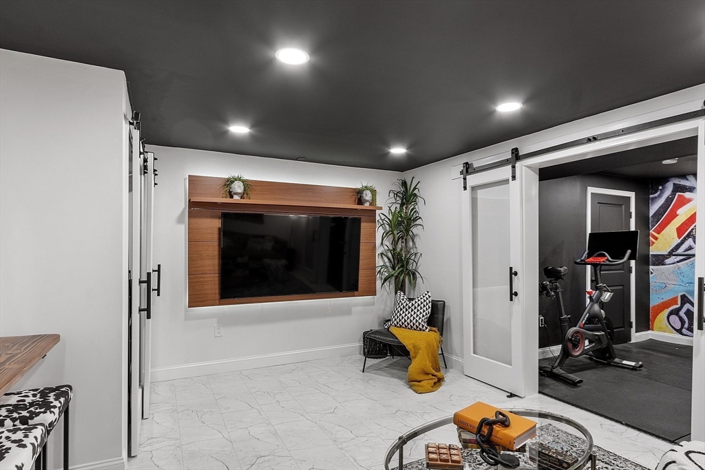 75 Chestnut Street Foxboro, MA 02035 - Photo 21 of 30 a living room with furniture and a flat screen tv