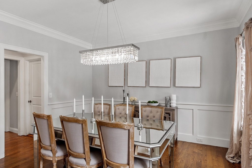75 Chestnut Street Foxboro, MA 02035 - Photo 6 of 30 a dining room with wooden floor a chandelier a wooden table and chairs