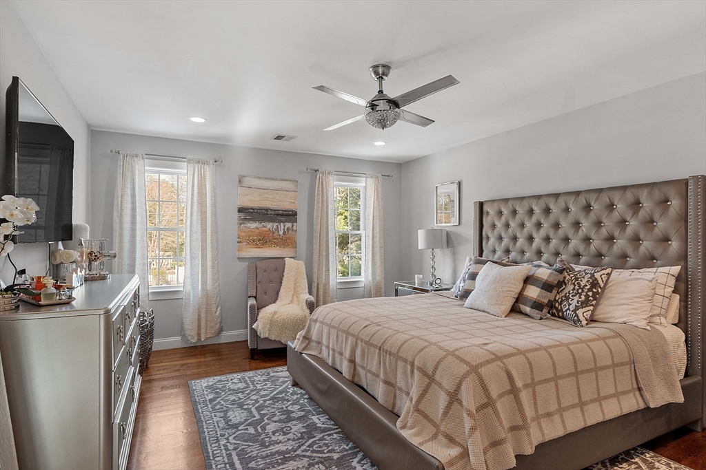 75 Chestnut Street Foxboro, MA 02035 - Photo 8 of 30 a bedroom with a large bed a chandelier and dresser