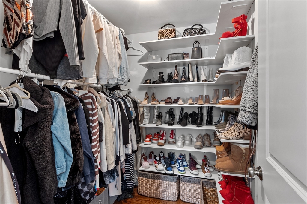 75 Chestnut Street Foxboro, MA 02035 - Photo 10 of 30 a view of walk in closet with clothes and shoes