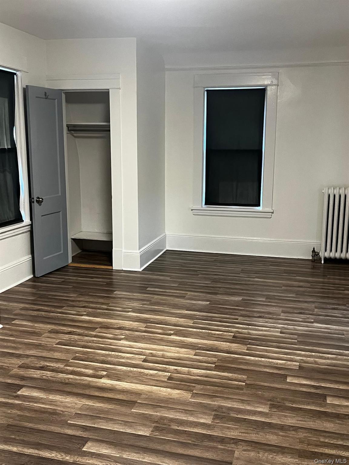440 Mile Square Road Yonkers, NY 10701 - Photo 20 of 29 Spacious room featuring wood-finish flooring, white baseboards, and a built-in closet with a gray door