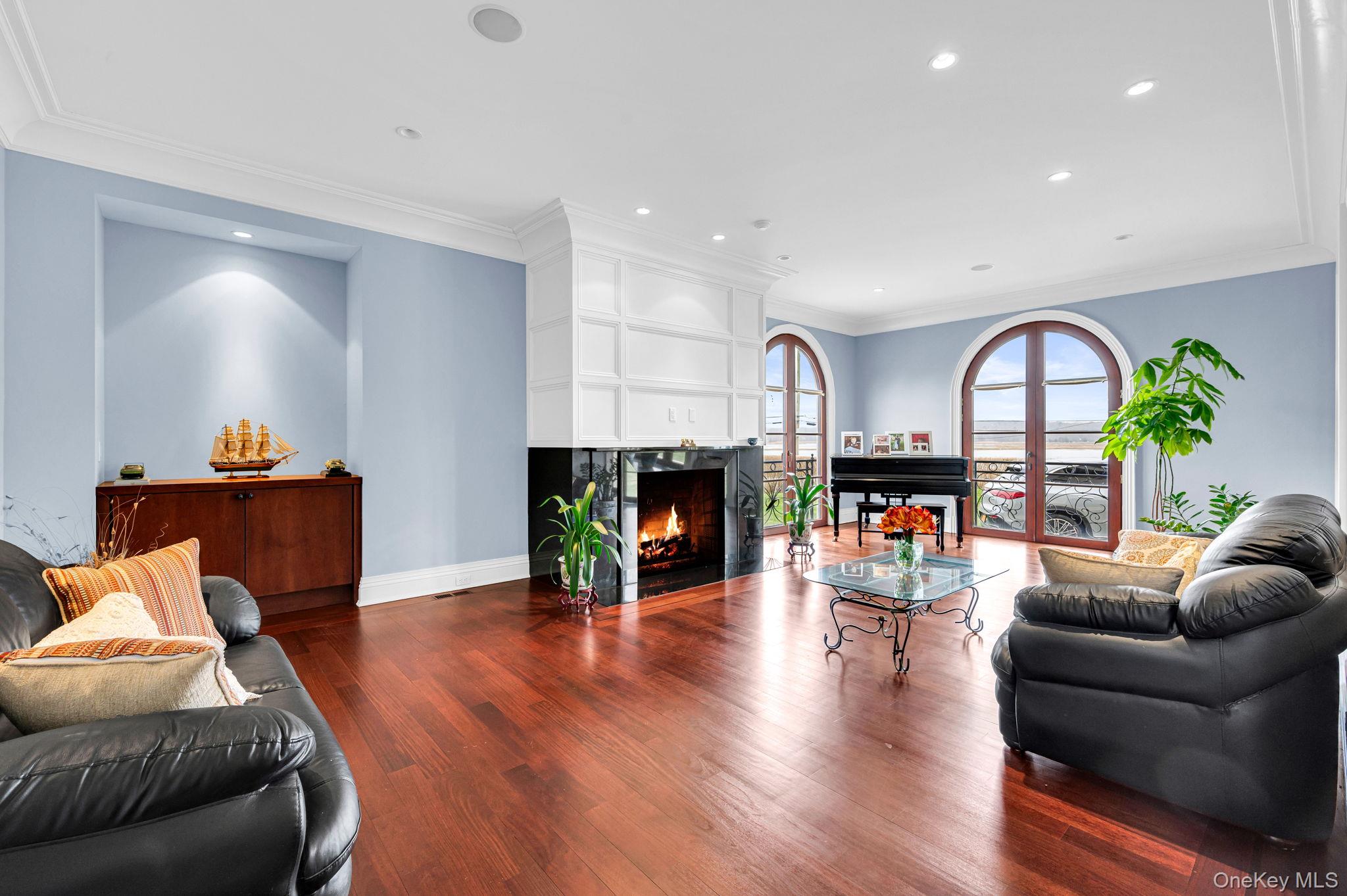 717 A Short Beach Road St. James, NY 11780 - Photo 12 of 50 a living room with furniture a fireplace and a wooden floor