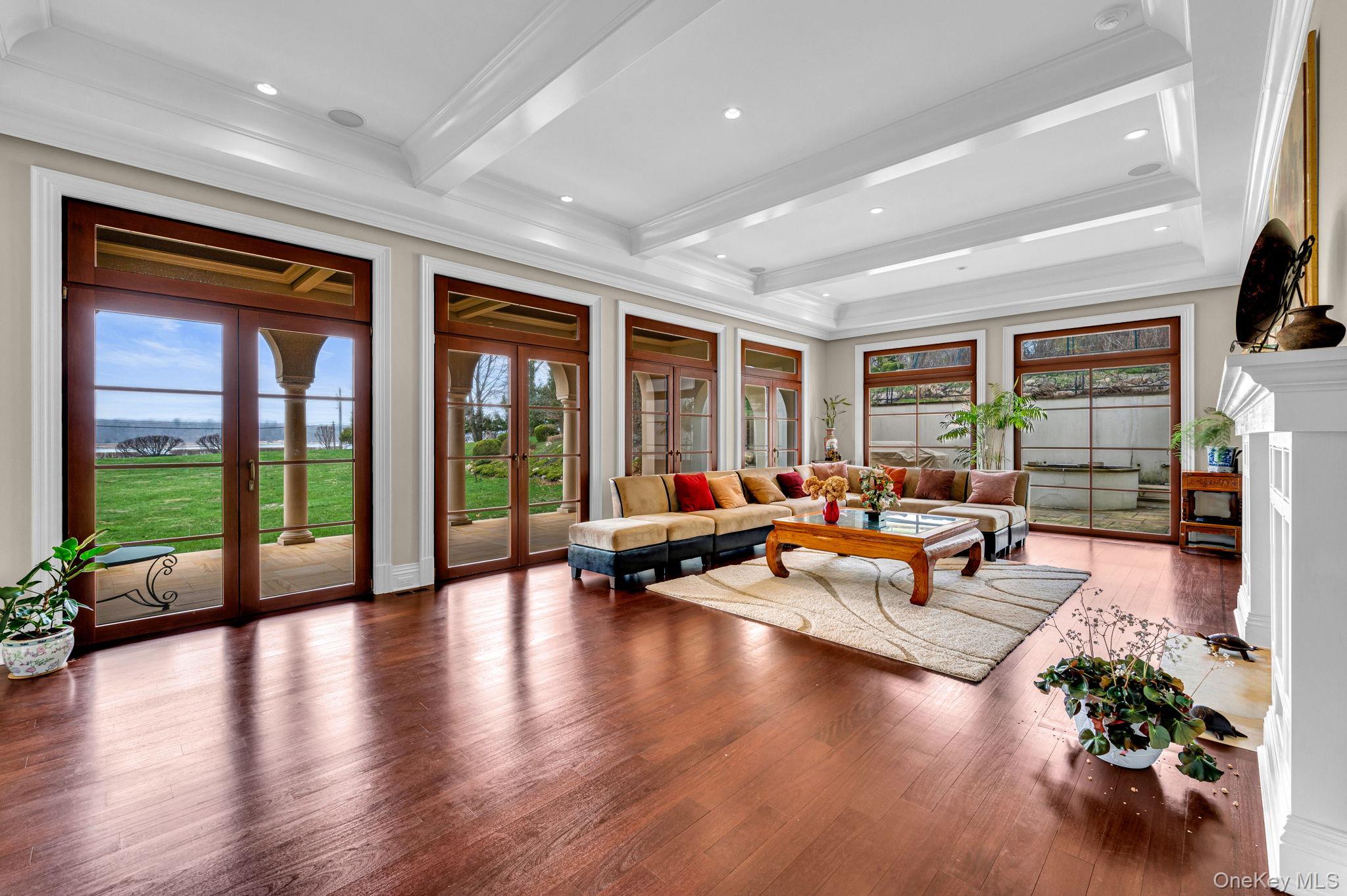 717 A Short Beach Road St. James, NY 11780 - Photo 9 of 50 a living room with furniture floor to ceiling window and wooden floor