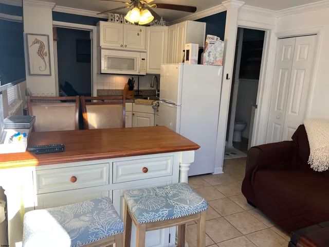 a kitchen with stainless steel appliances granite countertop a refrigerator a stove and a sink