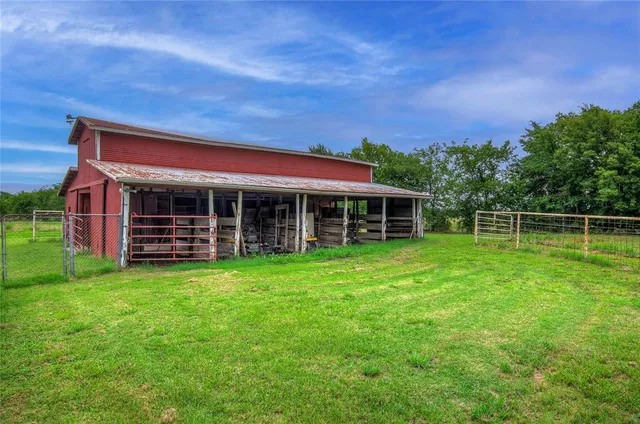 a view of house with backyard space and balcony