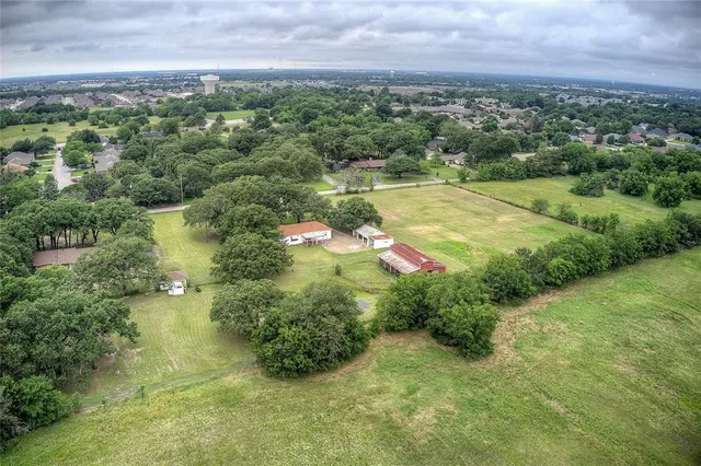 an aerial view of a houses with yard