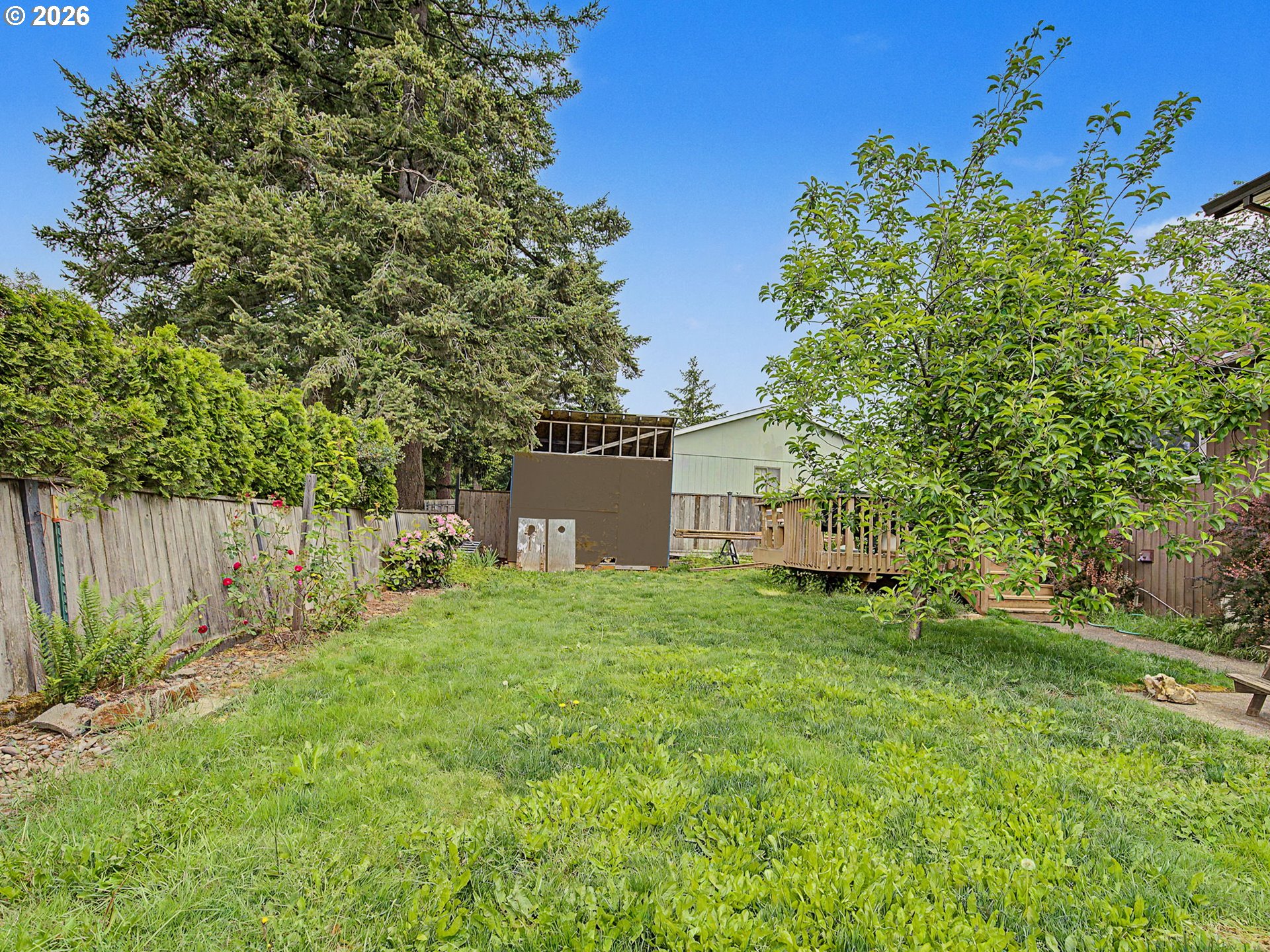 18015 Davis Street Sandy, OR 97055 - Photo 32 of 40 a backyard of a house with plants and trees