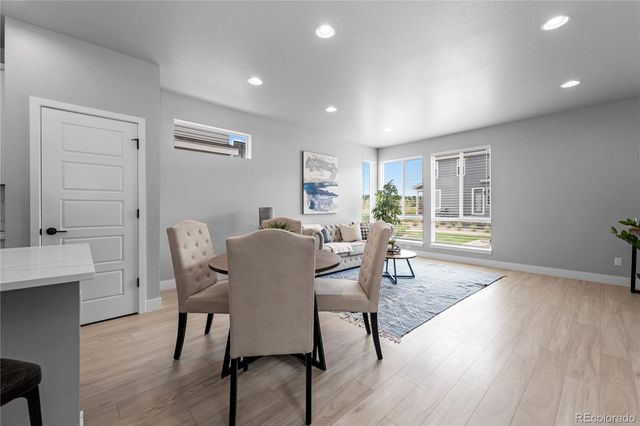 a view of a dining room with furniture window and wooden floor