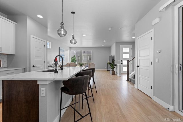 a view of a kitchen and dining area with chandelier