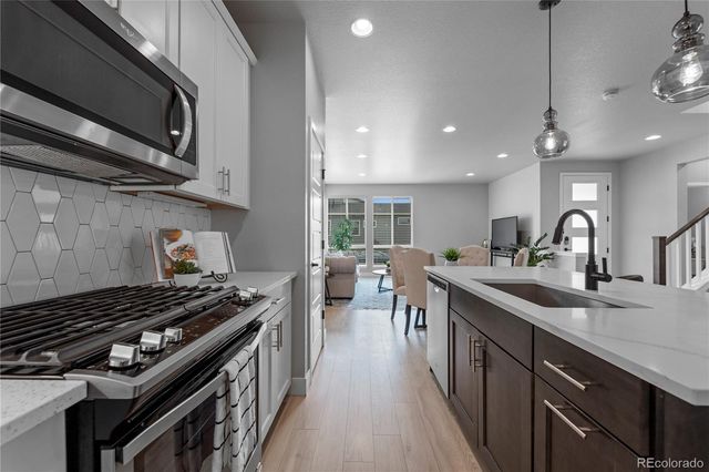 a kitchen with sink stove and cabinets