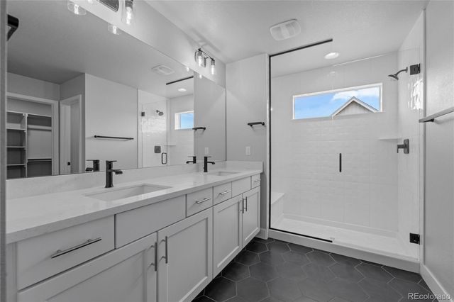 a spacious bathroom with a double vanity sink mirror and shower