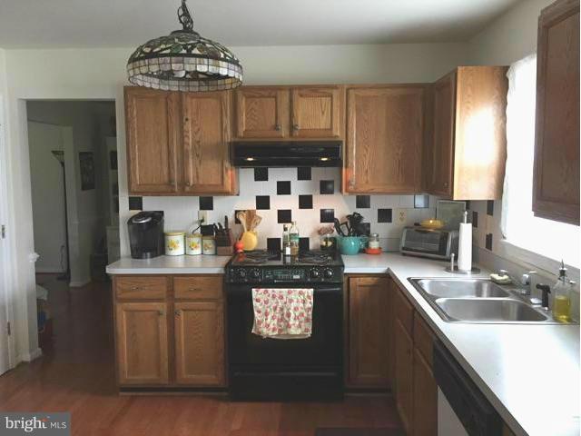 19 Markham Way Stafford, VA 22556 - Photo 4 of 23 a kitchen with stainless steel appliances granite countertop a stove refrigerator sink and cabinets