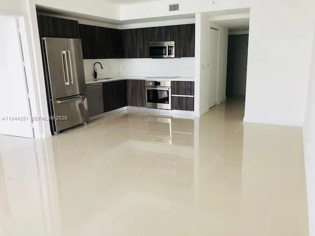 a kitchen with stainless steel appliances a refrigerator and stove