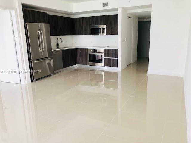 488 Northeast 18th Street, Unit 3703 Miami, FL 33132 - Photo 1 of 27 a kitchen with stainless steel appliances a refrigerator and stove