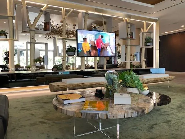 a dining room with furniture and a floor to ceiling window