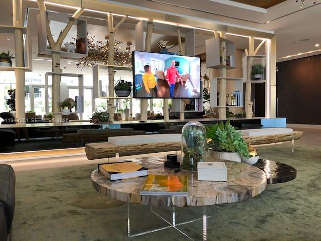 488 Northeast 18th Street, Unit 3703 Miami, FL 33132 - Photo 13 of 27 a dining room with furniture and a floor to ceiling window