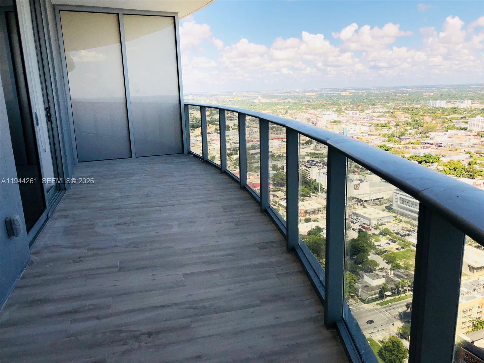 488 Northeast 18th Street, Unit 3703 Miami, FL 33132 - Photo 19 of 27 a view of balcony with wooden floor
