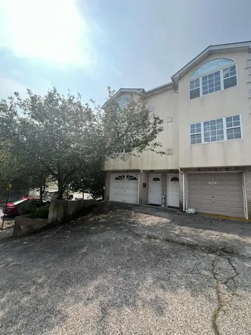 a view of a house with a yard and garage
