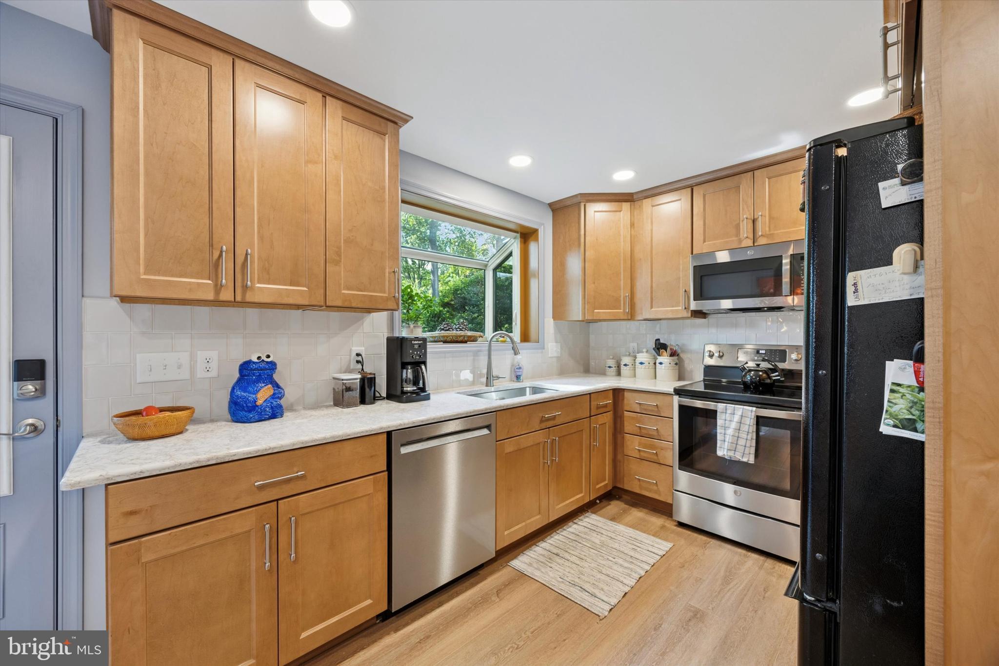 1208 Bruce Road Wilmington, DE 19803 - Photo 11 of 38 a kitchen with stainless steel appliances granite countertop a refrigerator a sink dishwasher a stove and white countertops with wooden floor