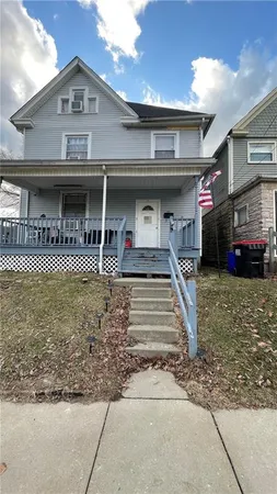 a front view of a house with lots of windows and couch