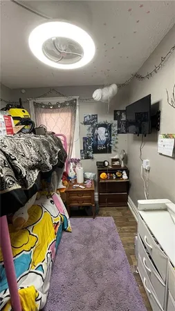 a bed room with furniture and a flat screen tv