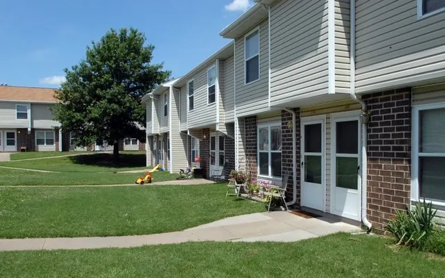 a view of a house with a backyard