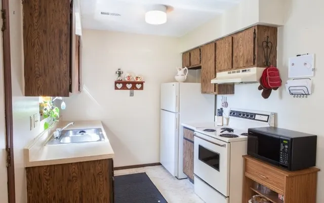 a kitchen with stainless steel appliances a stove a microwave and a refrigerator