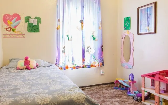 a bedroom with a bed and a window