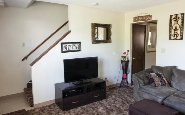 a living room with furniture and a flat screen tv