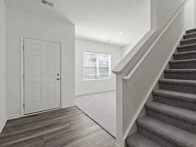 a view of entryway with wooden floor and stairs