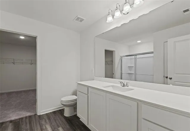 a bathroom with a toilet a sink and mirror