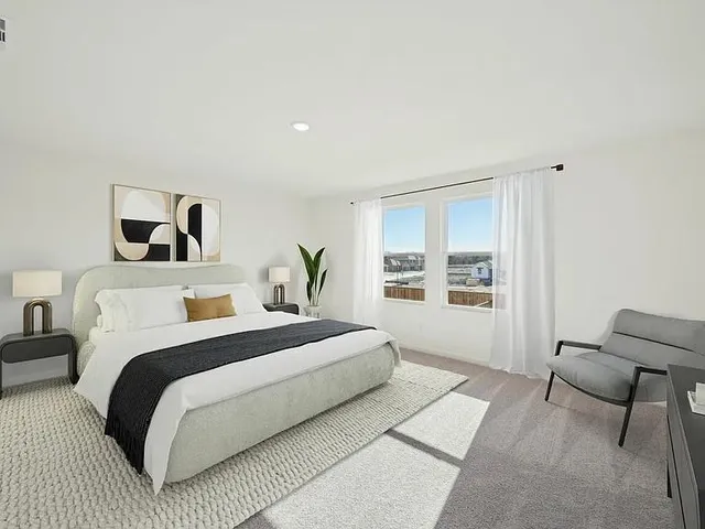 a bedroom with a large bed and a window