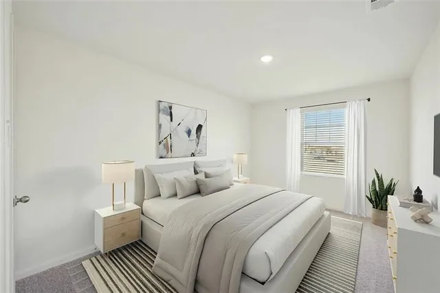 a bedroom with a bed and a potted plant