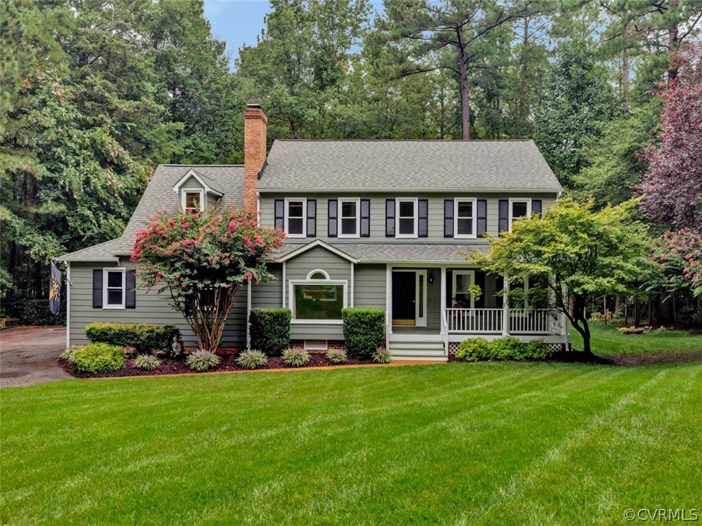 a front view of a house with a garden and plants