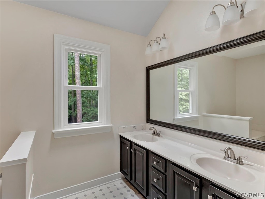 14042 Princess Mary Road Chesterfield, VA 23838 - Photo 18 of 31 a bathroom with a double vanity sink and a window