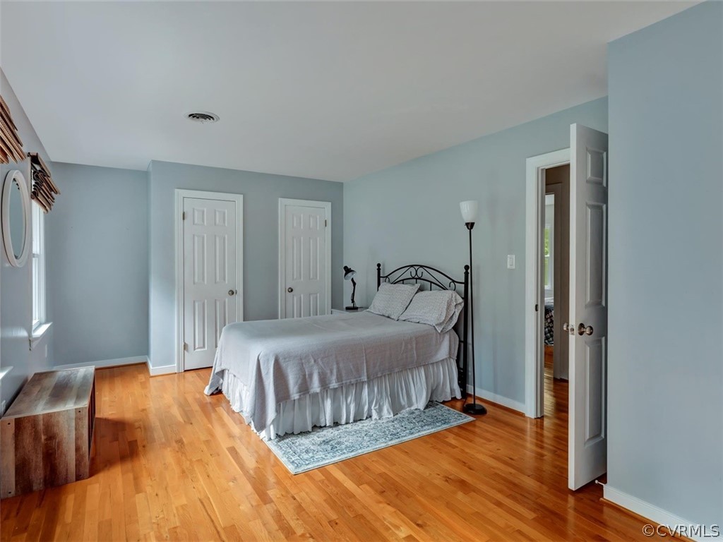14042 Princess Mary Road Chesterfield, VA 23838 - Photo 21 of 31 a bedroom with a bed and wooden floor