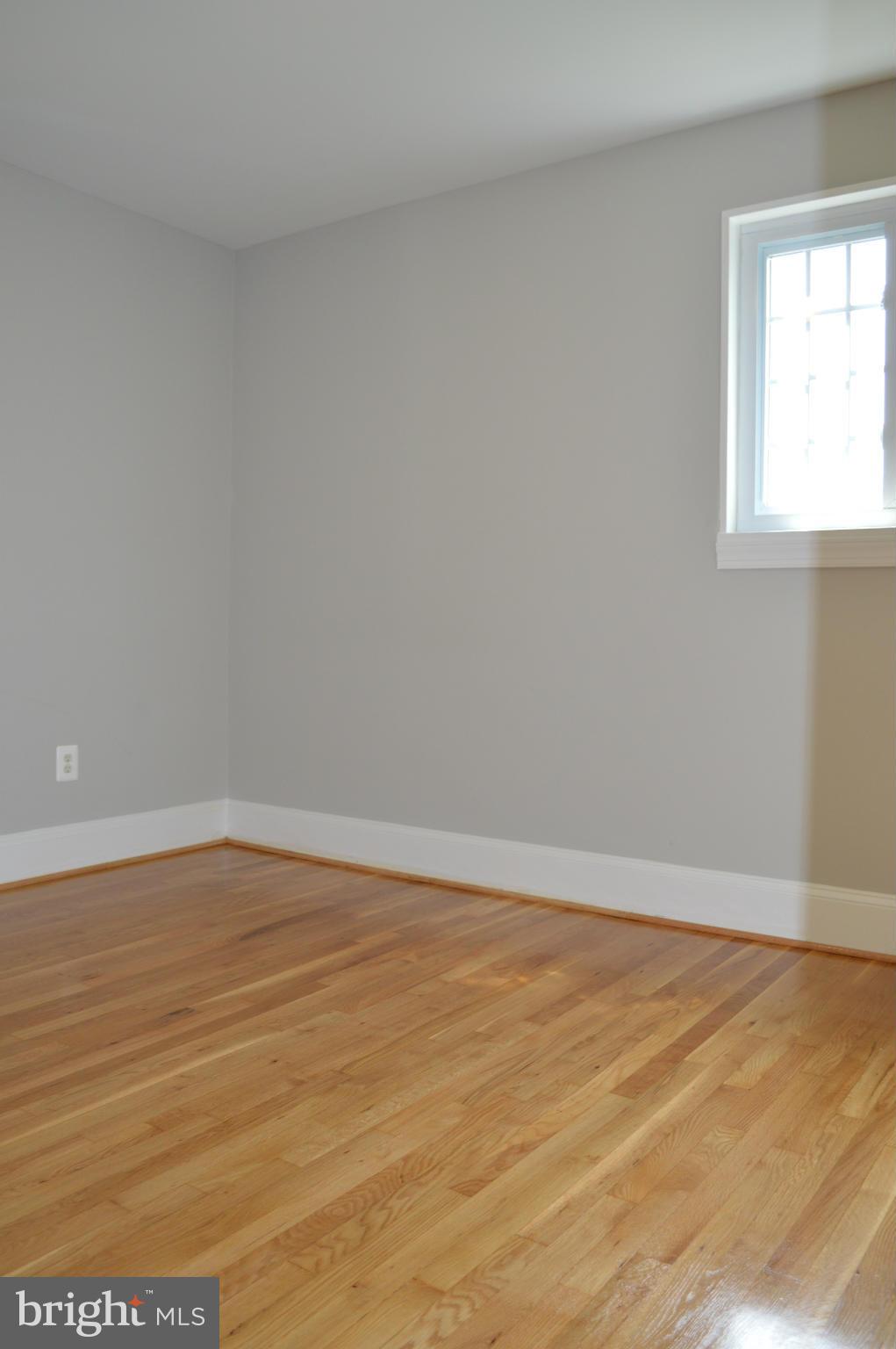 4238 Isbell Street Silver Spring, MD 20906 - Photo 11 of 22 a view of an empty room with wooden floor and a window