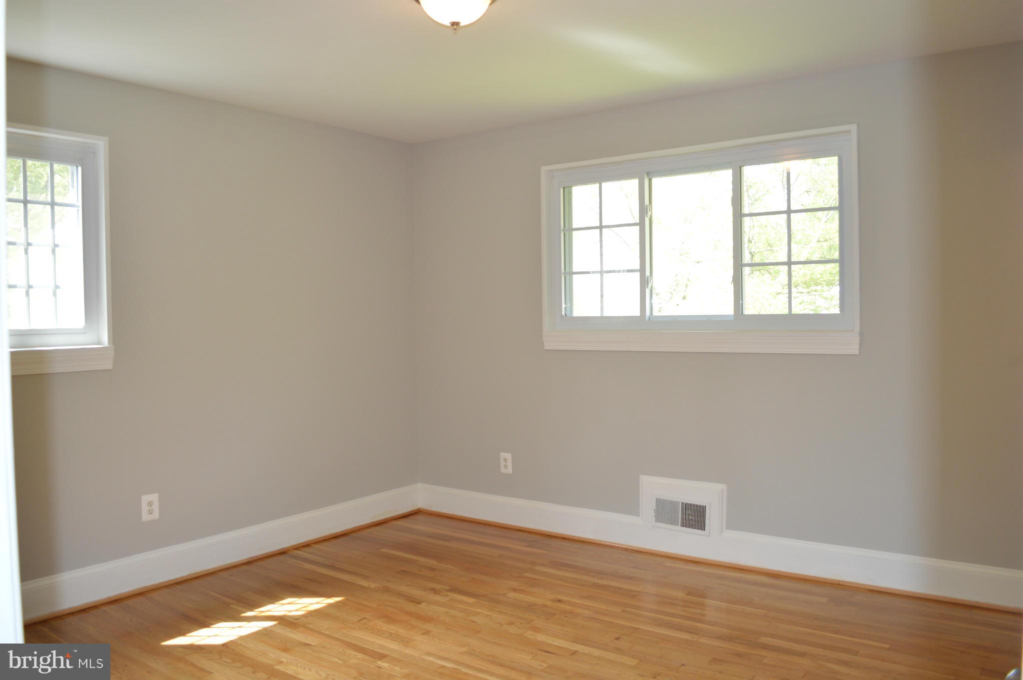 4238 Isbell Street Silver Spring, MD 20906 - Photo 13 of 22 an empty room with wooden floor and windows