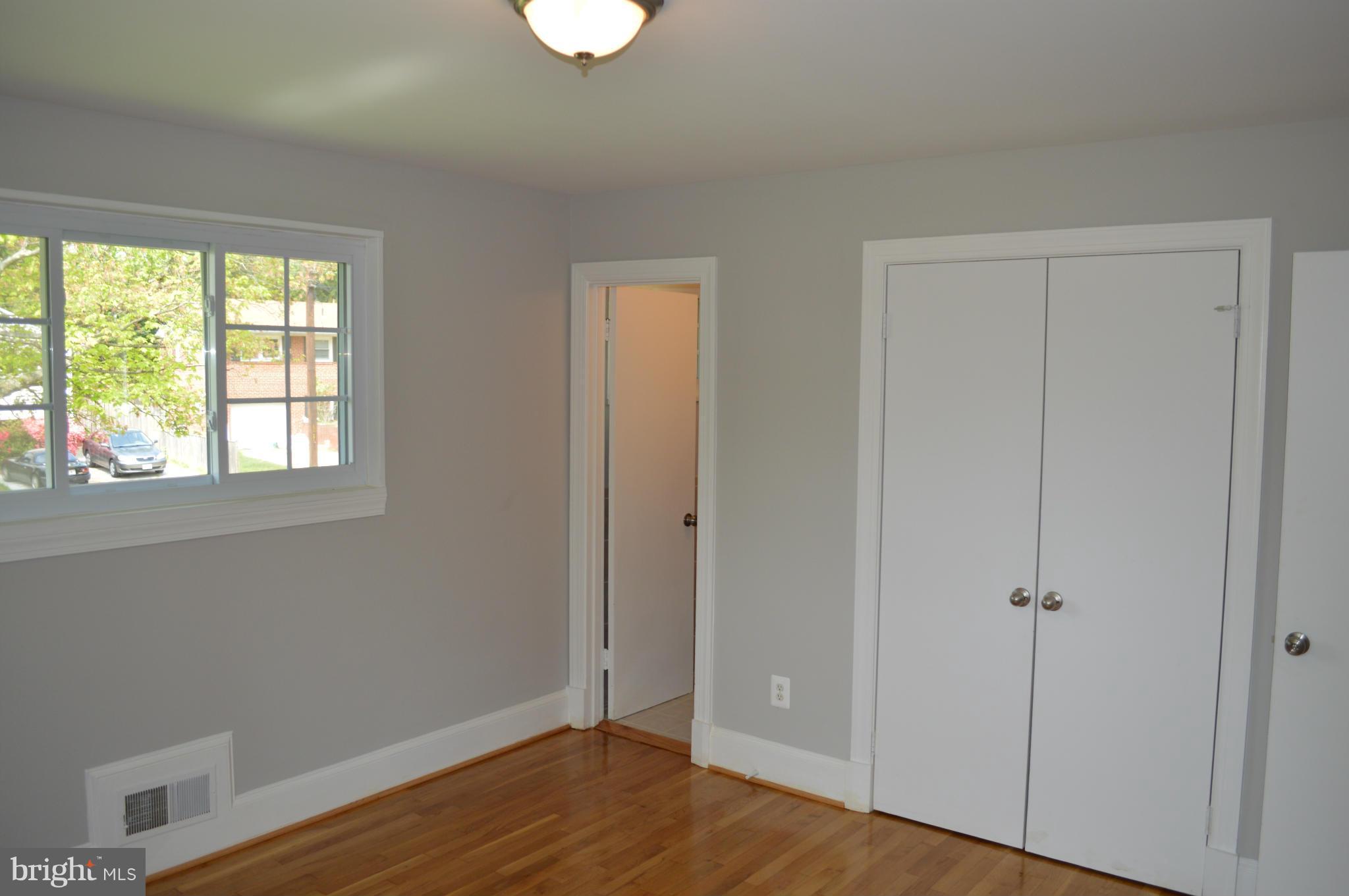 4238 Isbell Street Silver Spring, MD 20906 - Photo 14 of 22 a view of an empty room with wooden floor and a window