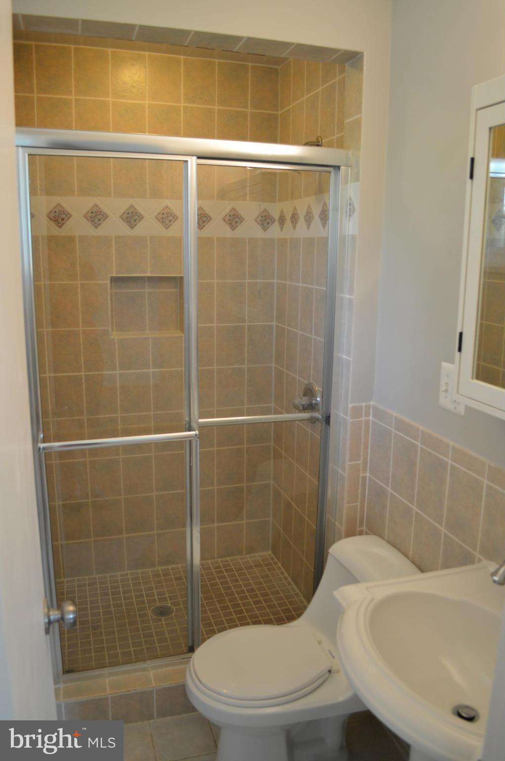 4238 Isbell Street Silver Spring, MD 20906 - Photo 15 of 22 a bathroom with a toilet and shower