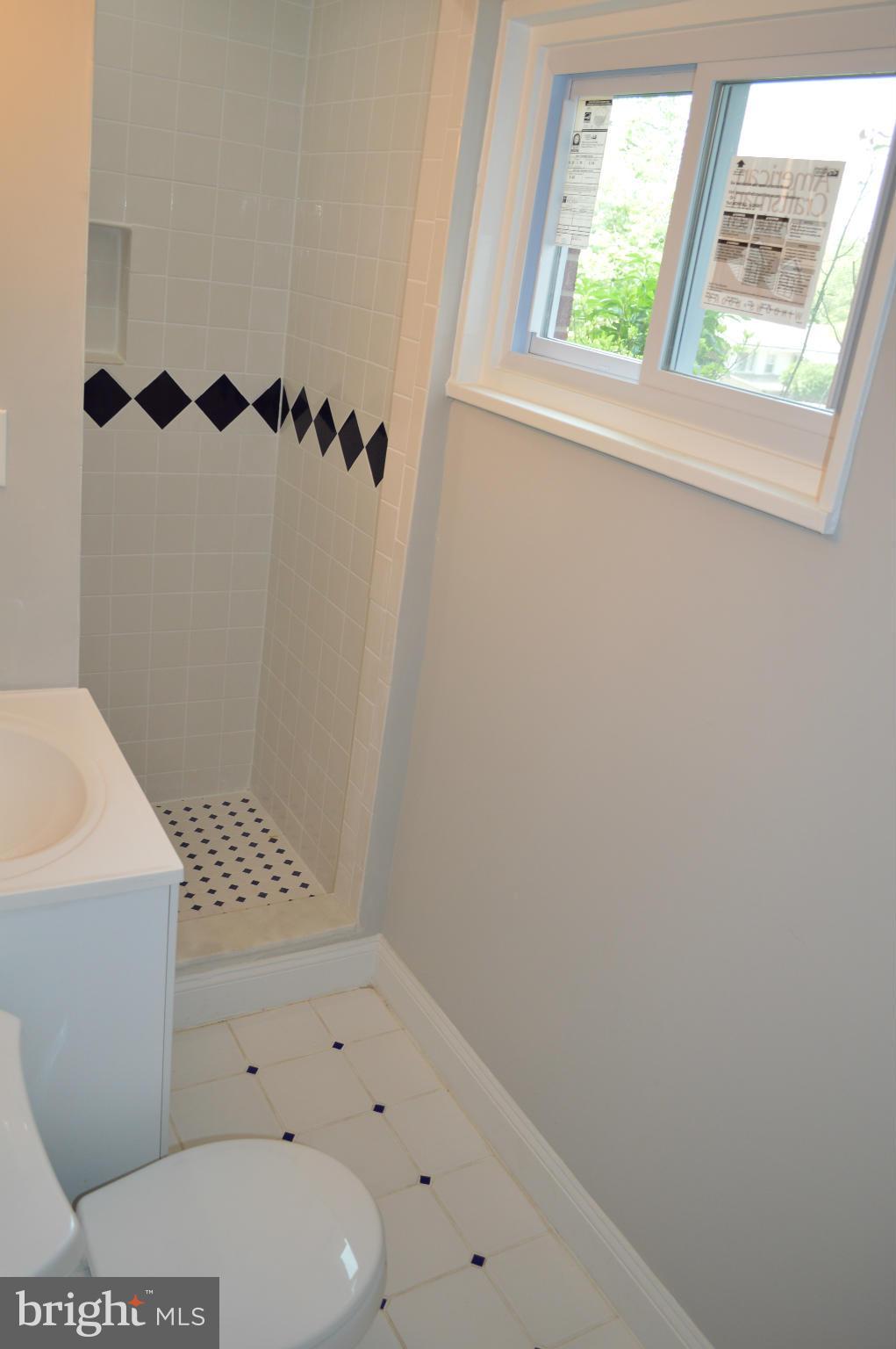 4238 Isbell Street Silver Spring, MD 20906 - Photo 17 of 22 a bathroom with a bathtub and a shower