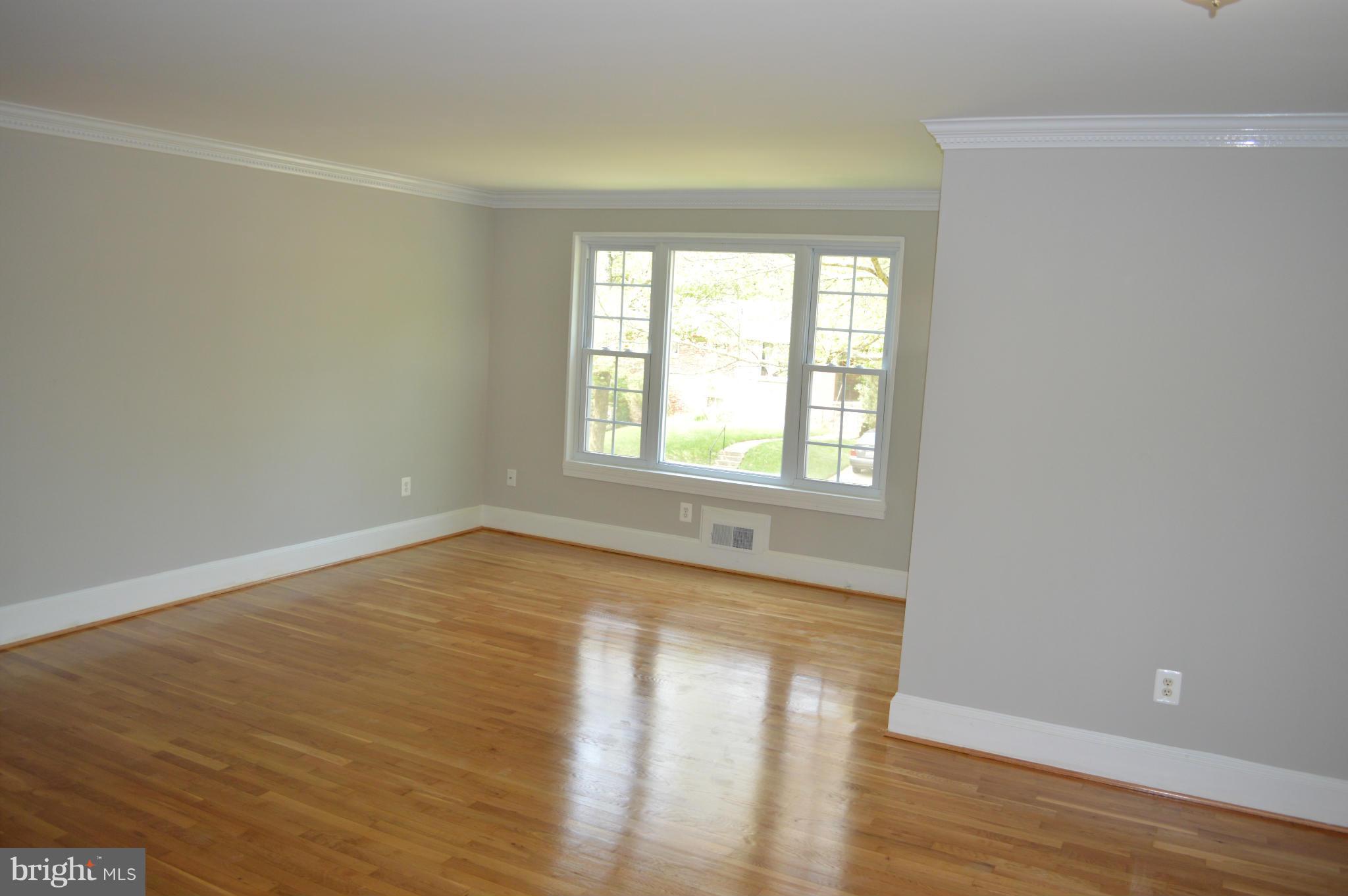 4238 Isbell Street Silver Spring, MD 20906 - Photo 3 of 22 a view of an empty room with wooden floor and a window